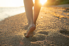 Woman walking on the sandy beach.