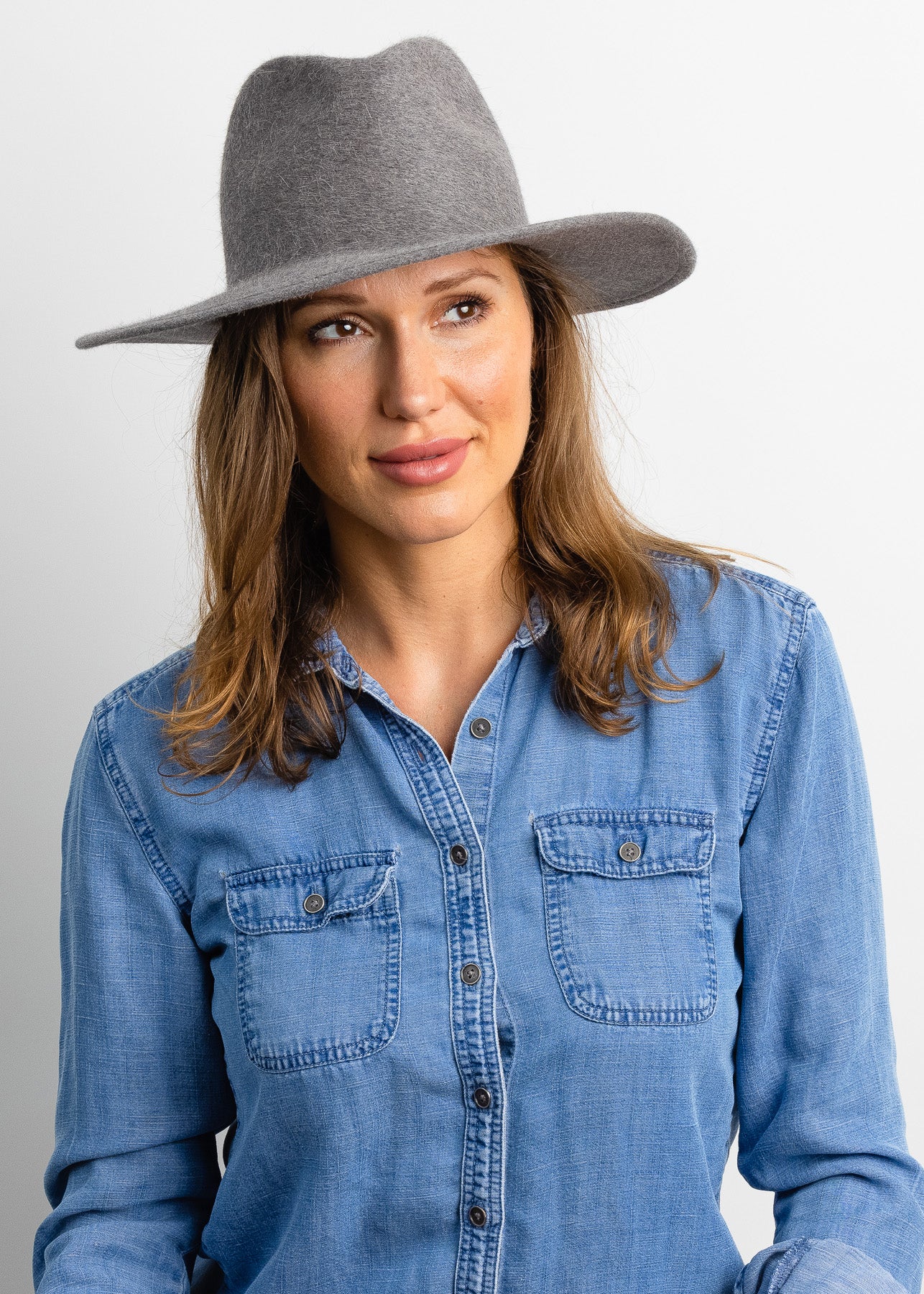 Model wearing grey velour brimmed hat