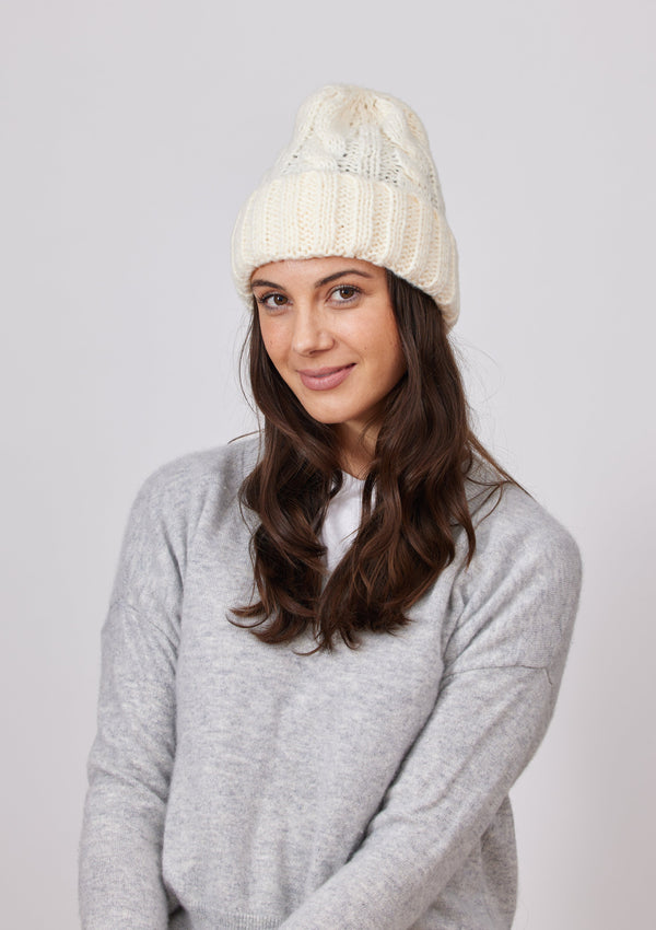 Ivory cable knit cuffed beanie on model