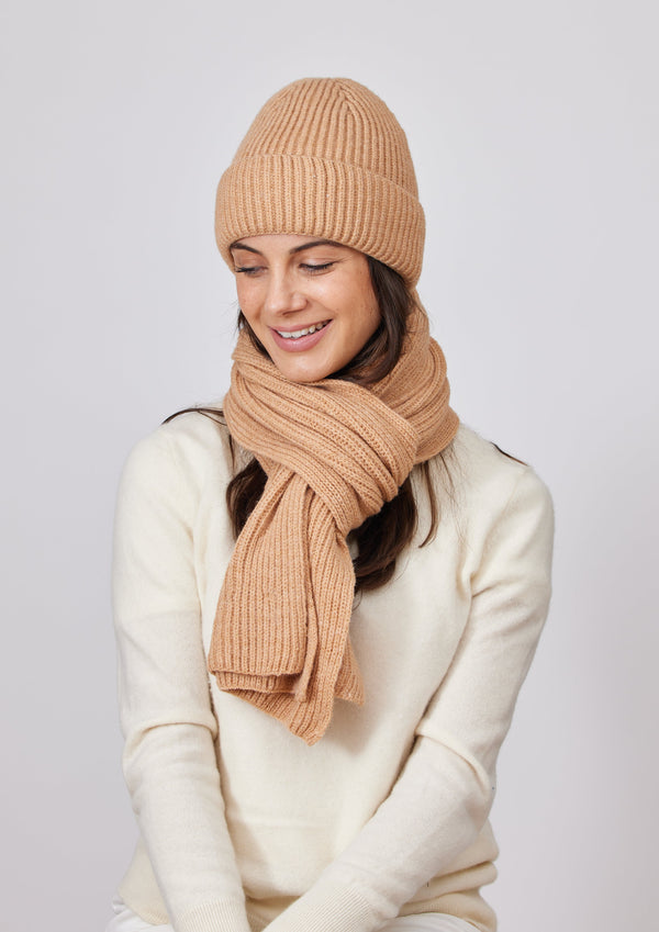 Model wearing camel brown ribbed knit beanie and scarf