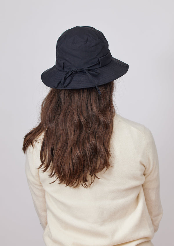 Back of black water resistant bucket hat on model