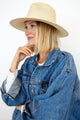 Model wearing tan perforated and vented sun hat with denim jacket