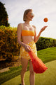 Model holding orange cotton mini bag