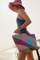 Model holding colorful tote