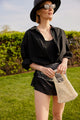 Model holding light tan cotton mini bag
