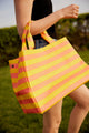 Close up of yellow and coral striped bag