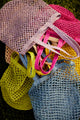 Assortment of colorful straw fisherman bags