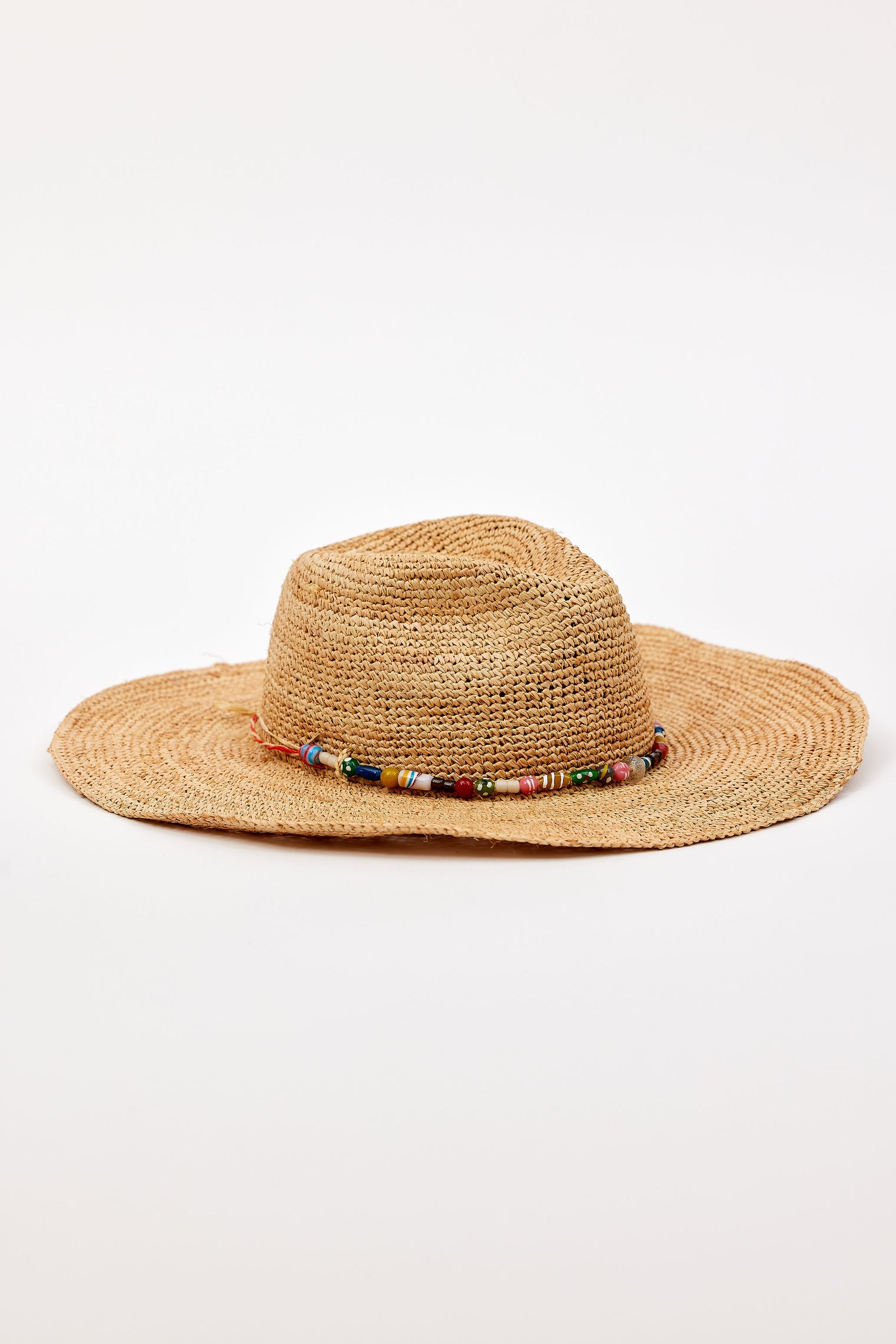Raffia hat with a beaded band on a white background