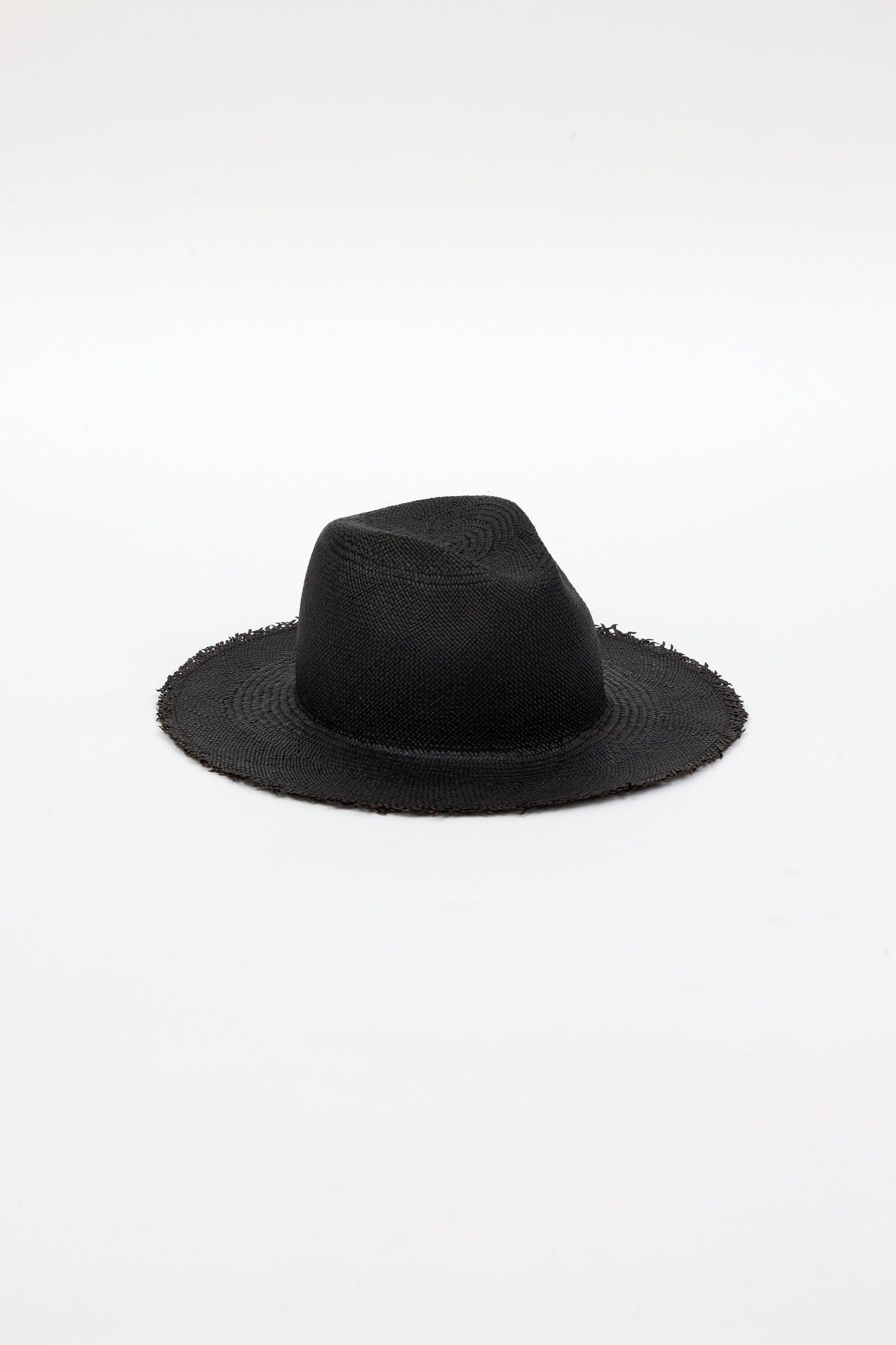 3/4 angle of black straw panama hat with fringe