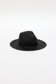 3/4 angle of black straw panama hat with fringe