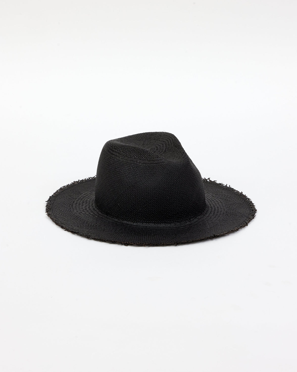 3/4 angle of black straw panama hat with fringe
