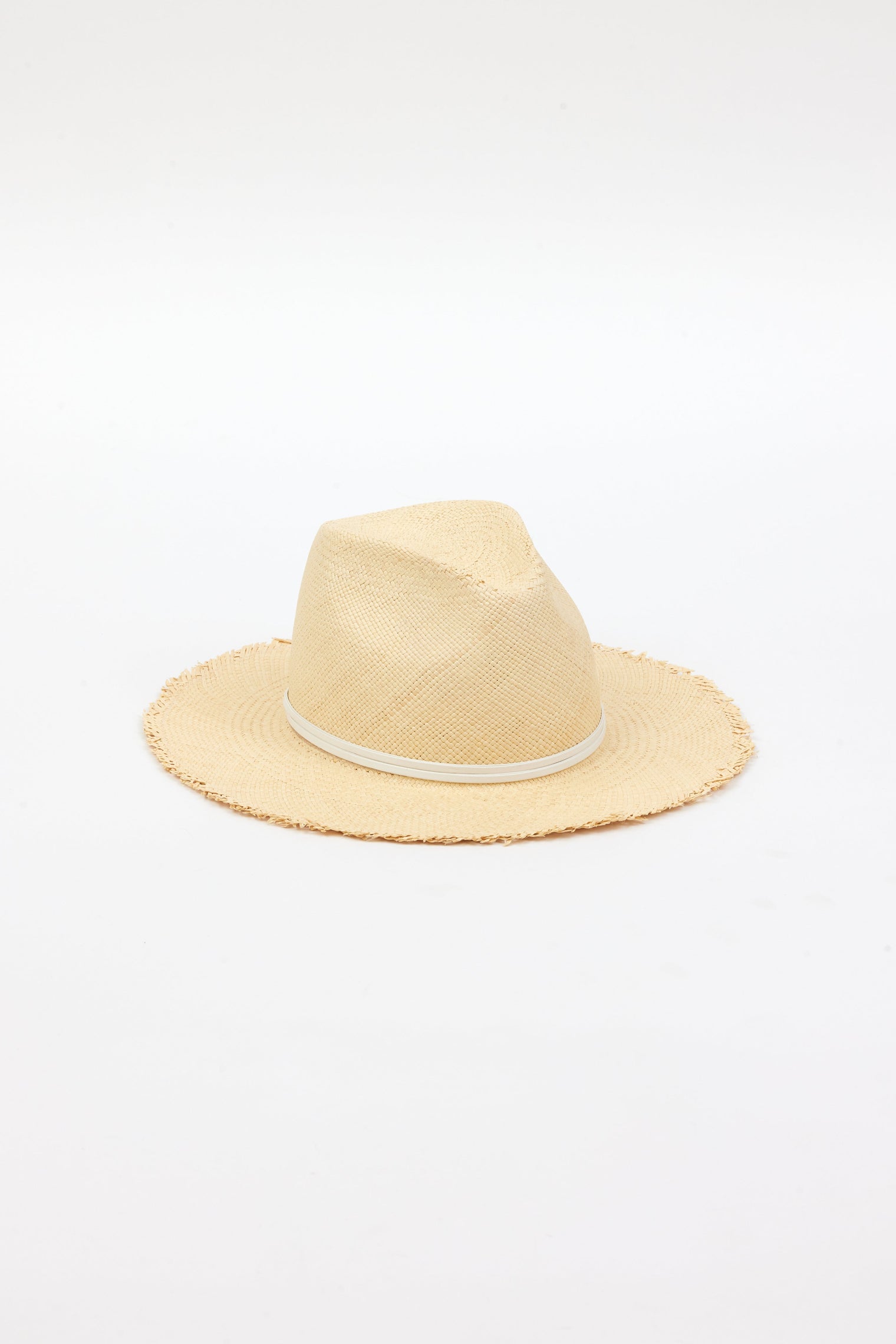 3/4 angle of natural fringed panama hat with white trim
