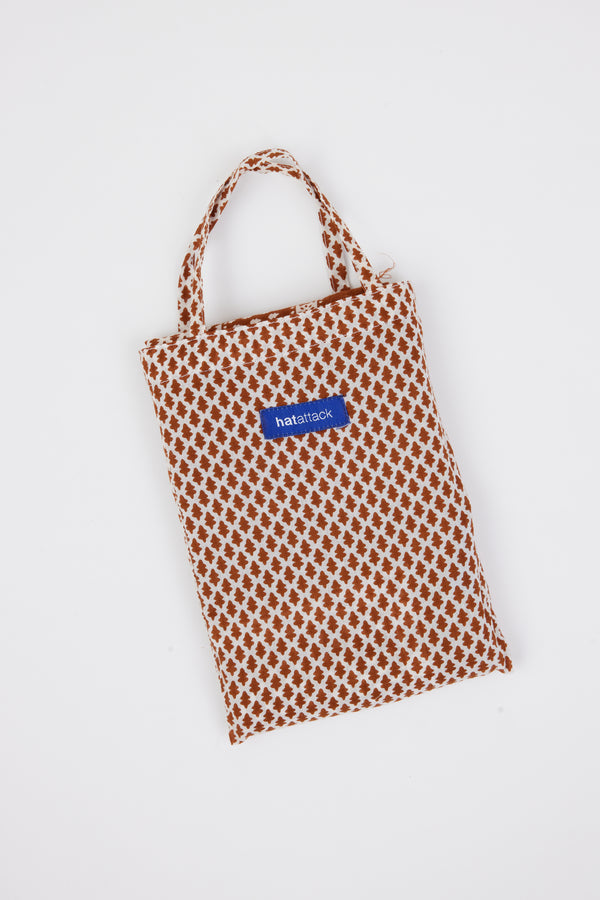 Brown and white sarong bag