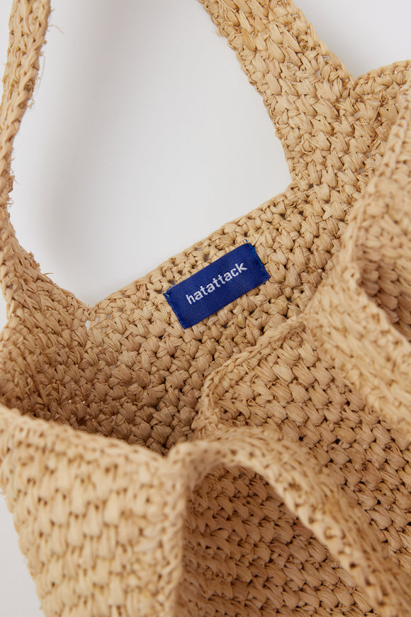 Inside of small structured natural woven straw bag