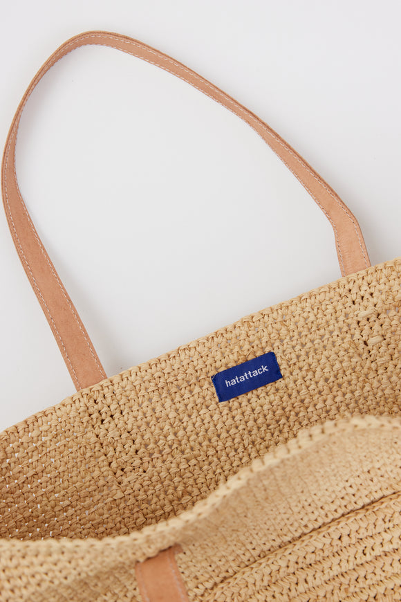 Inside of raffia straw tote with leather handles