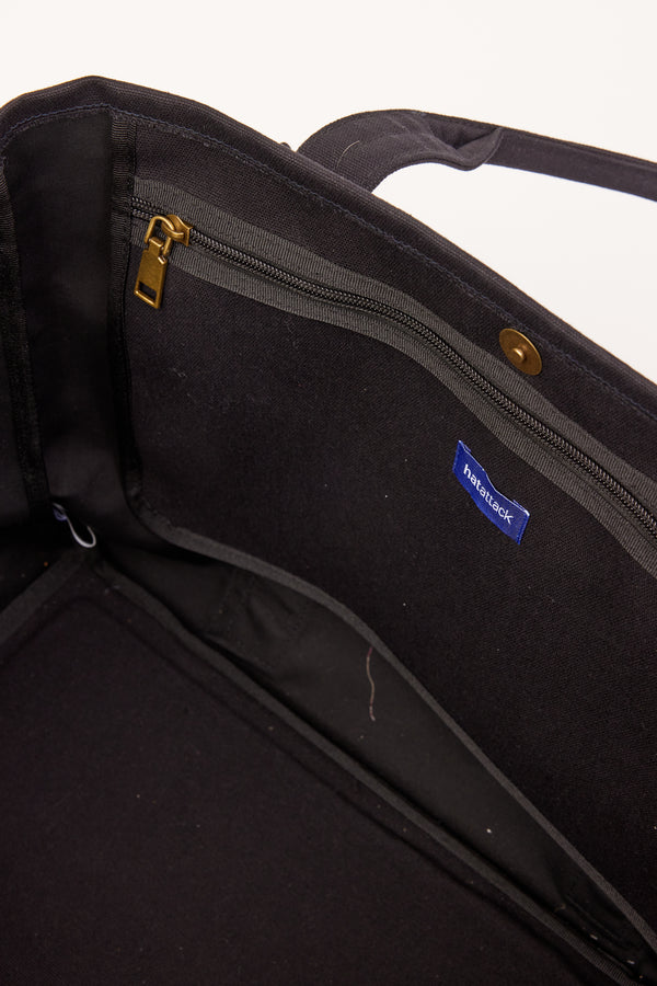 Inside of black tote with pockets