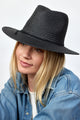 Model wearing black straw fedora