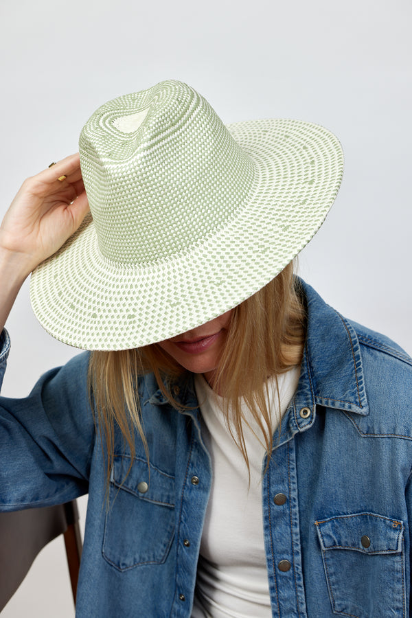 Model wearing mint and natural colored sun hat and denim shirt