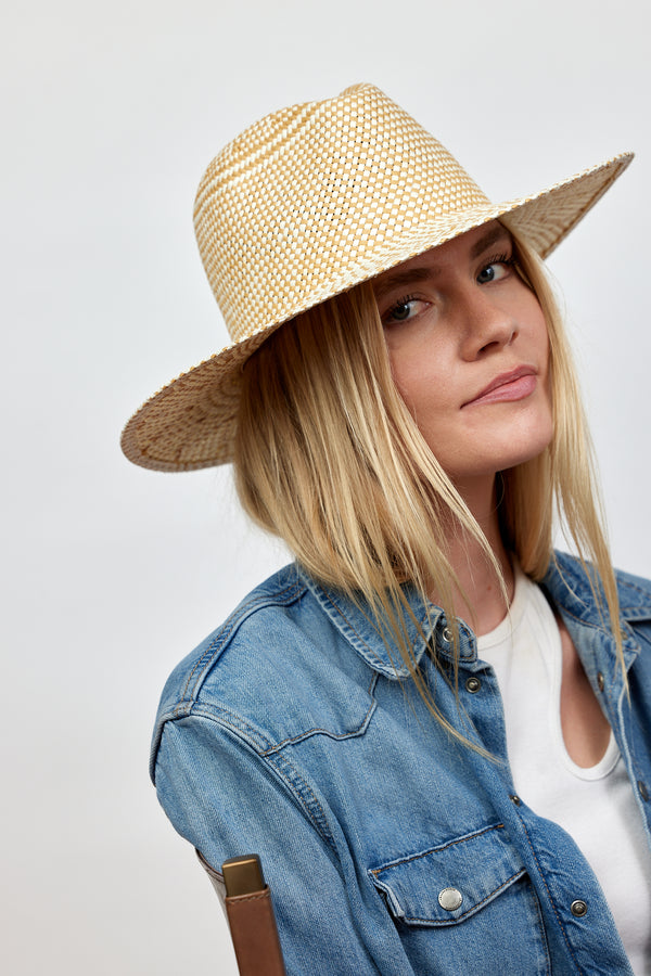 Model wearing tan and white woven sun hat
