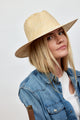 Model wearing tan and white woven sun hat