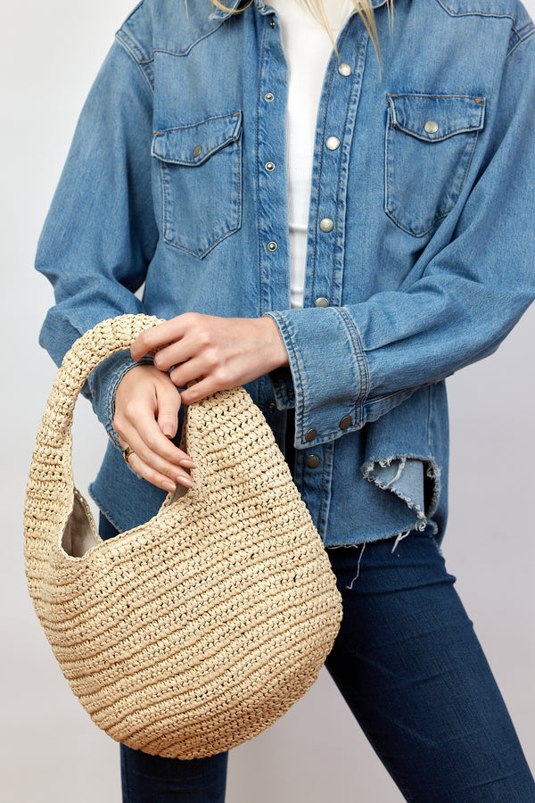 Model holding paper straw slouchy bag