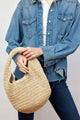 Model holding paper straw slouchy bag