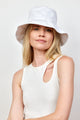 Model wearing white cotton bucket hat and white tank top