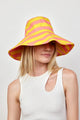 Model wearing coral and yellow striped bucket hat