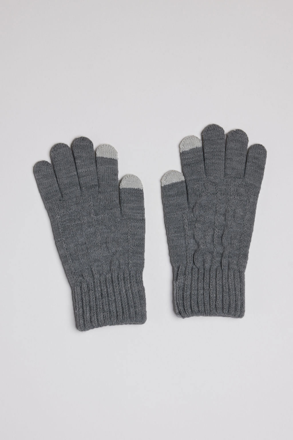 Pair of gray gloves with touchscreen tips on a light gray background