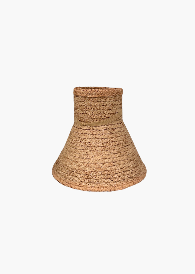 Rolled up beige straw visor hat on a white background