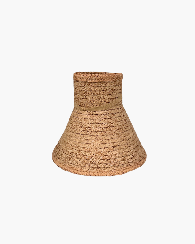 Rolled up beige straw visor hat on a white background