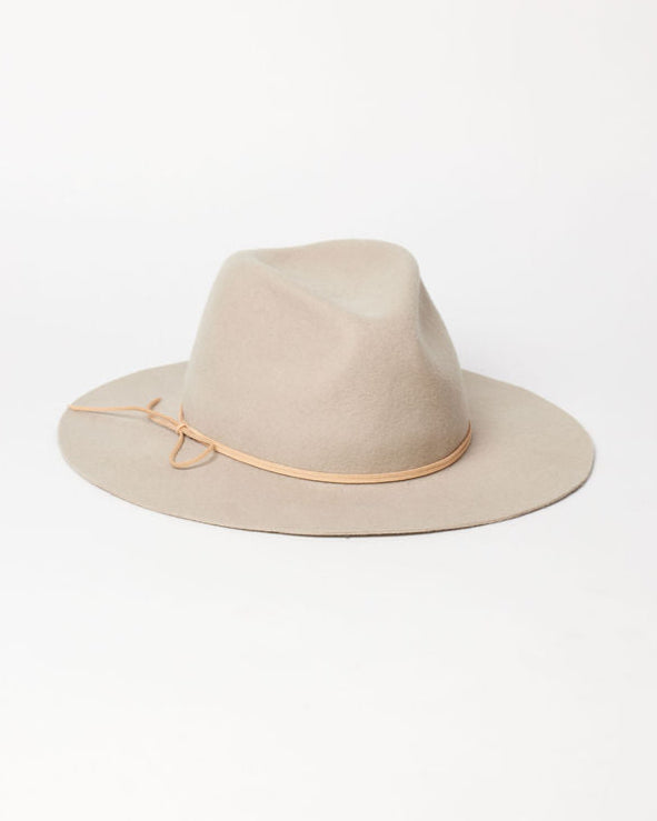 Beige fedora hat with a thin brown band on a white background