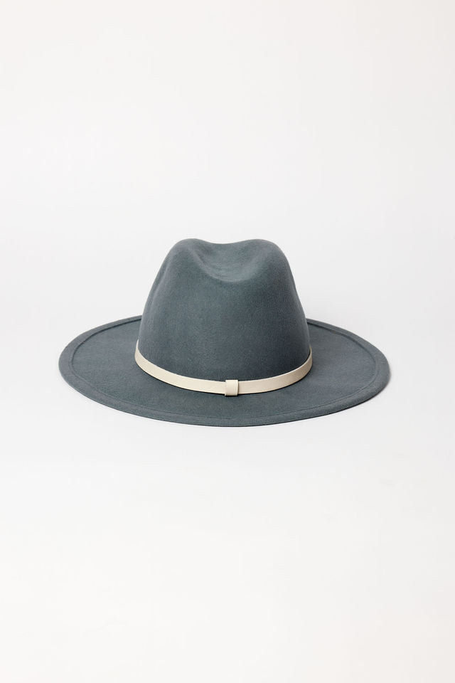 Blue fedora hat with a white band on a light gray background