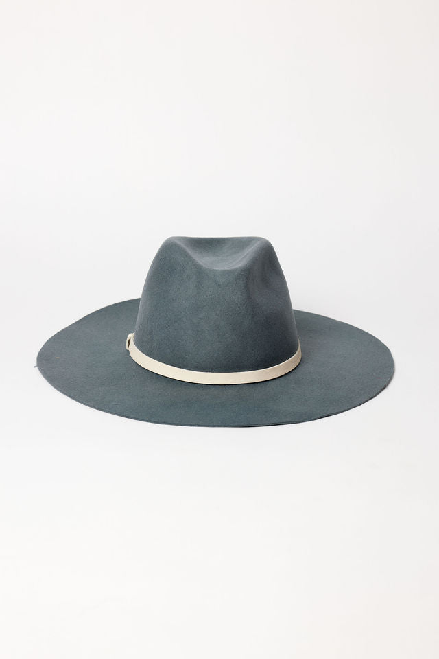 Blue fedora hat with a white band on a light gray background