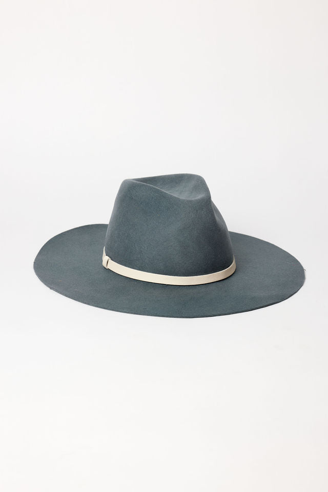 Blue fedora hat with a white band on a white background