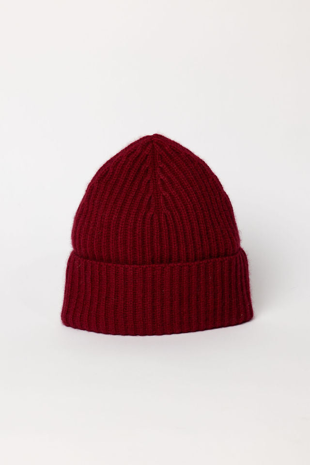 Maroon knit beanie on a white background