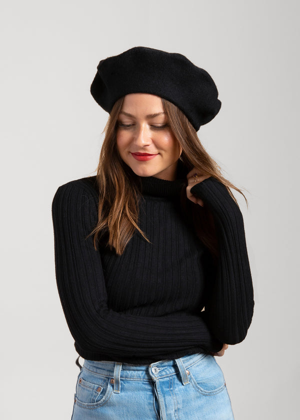 Model wearing black wool felt beret and black sweater