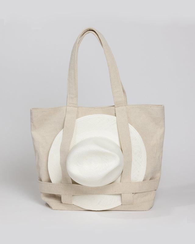 Tan canvas tote bag with white sun hat attached