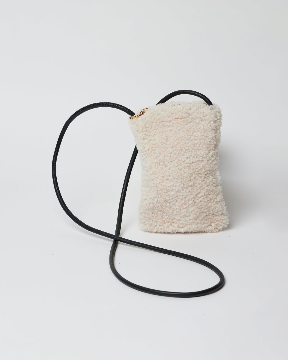Ivory sherpa phone bag with black crossbody strap