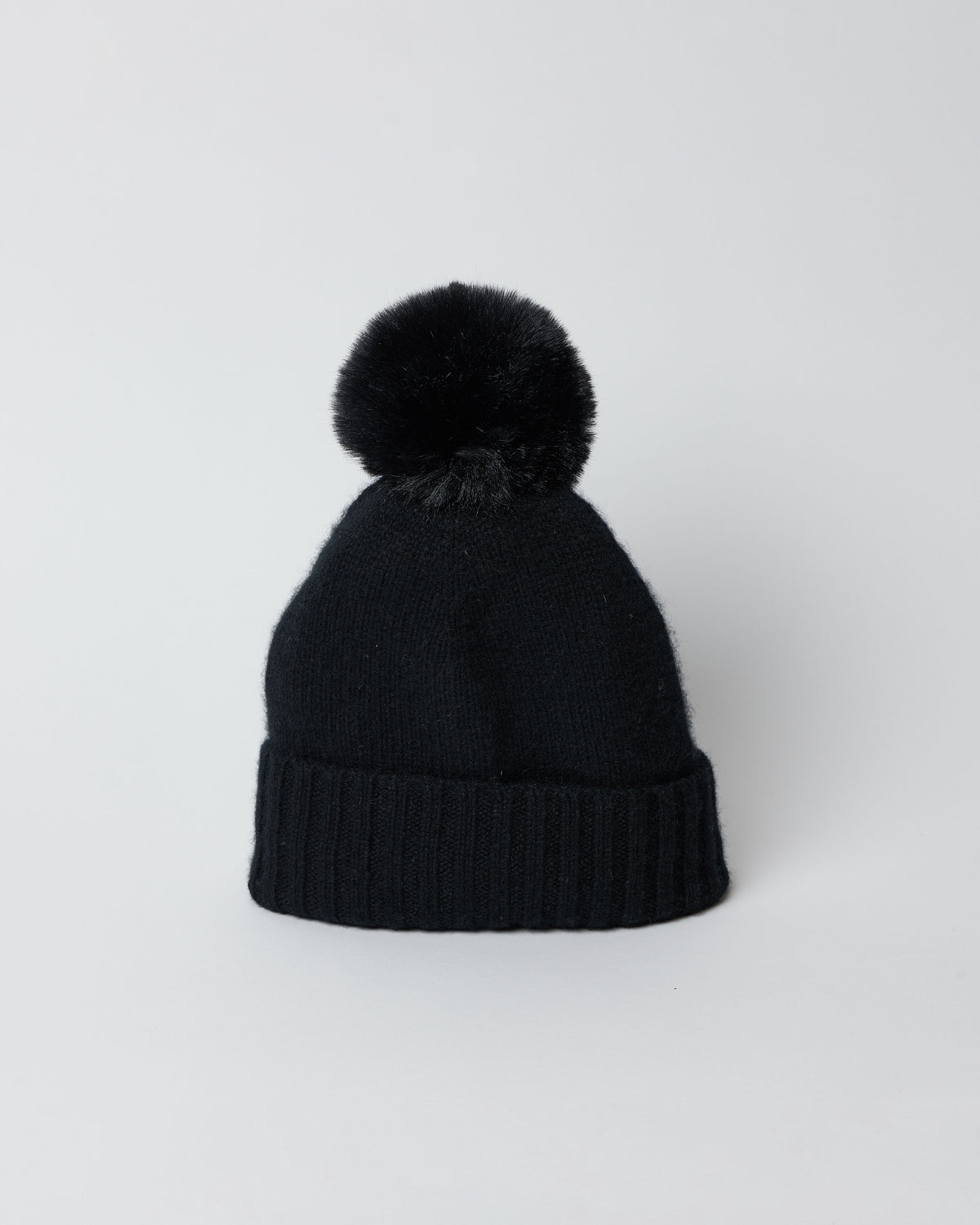 Black cashmere slouchy cuffed beanie with faux fur pom