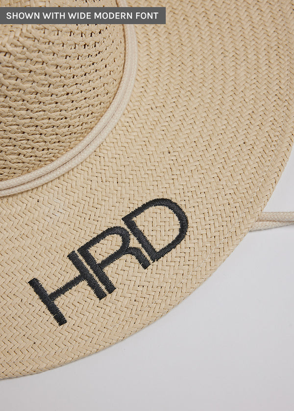 Close up of black embroidery on surfer style sun hat