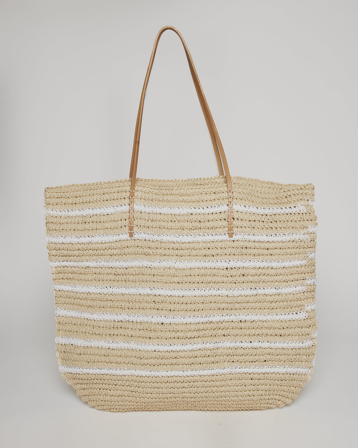 Straw tote with white stripes and leather handles