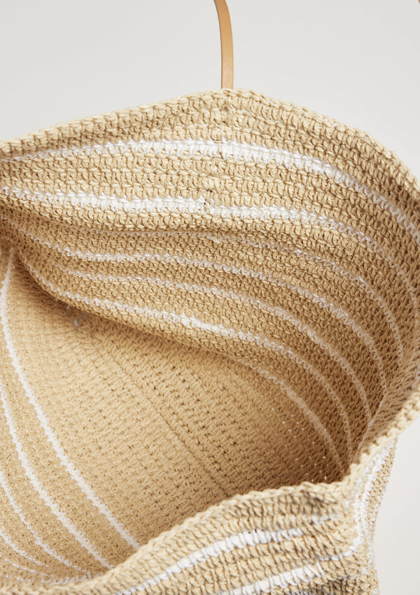 Inside of straw bag with white stripes