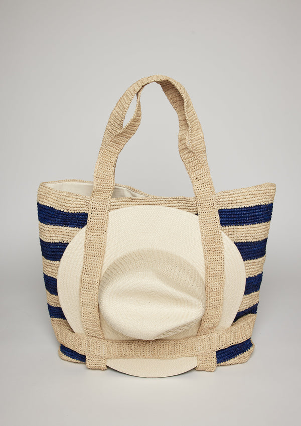 Navy striped straw tote bag with a white sun hat attached