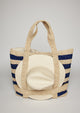 Navy striped straw tote bag with a white sun hat attached 