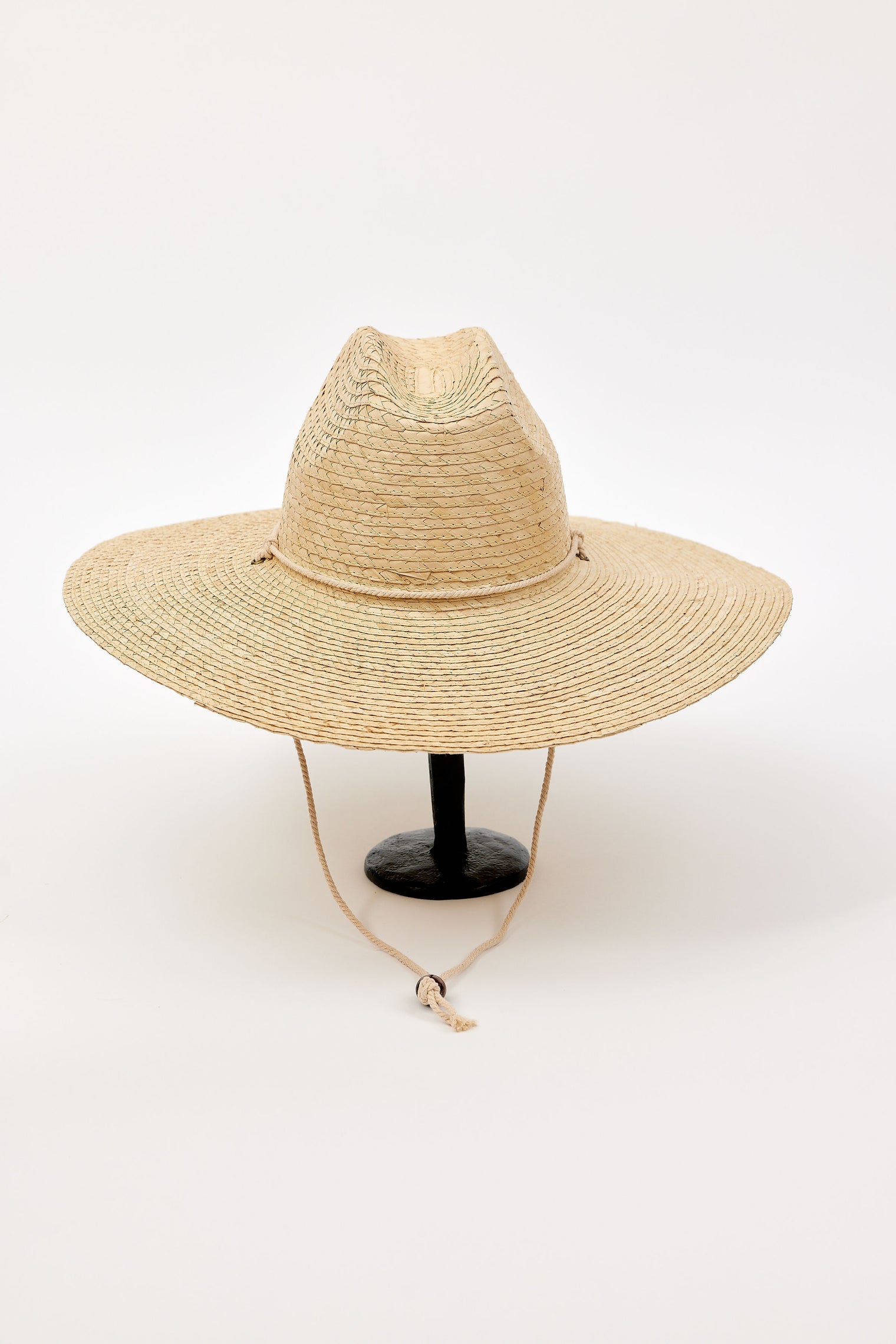 Beige straw hat on a white background