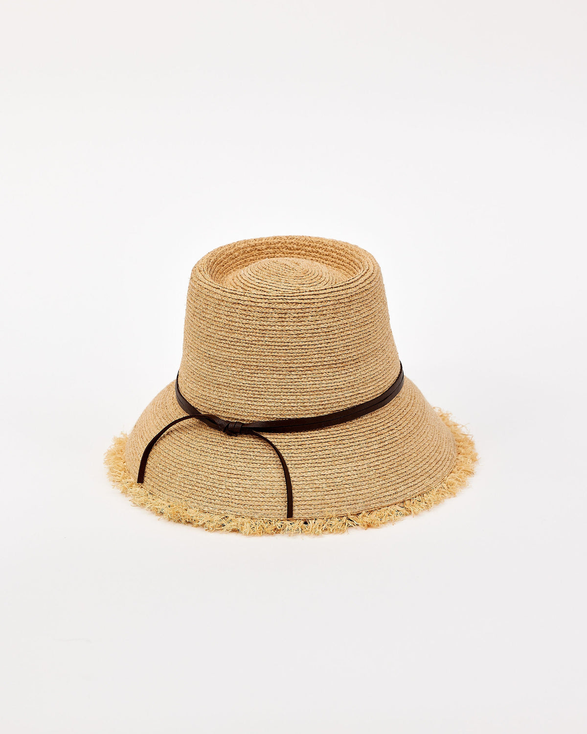 Beige straw bucket hat with a black band on a light beige background