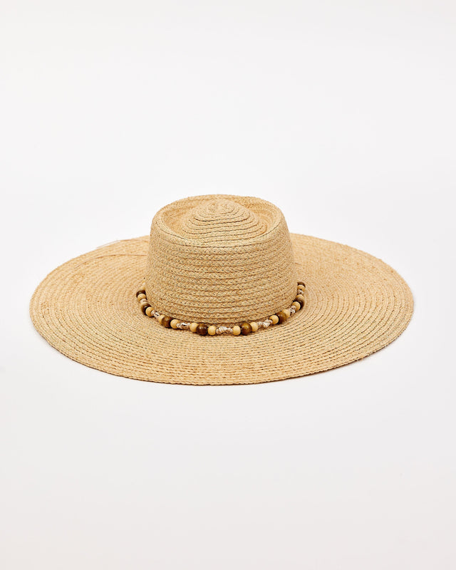 Beige straw hat with a wide brim and decorative beads on a white background