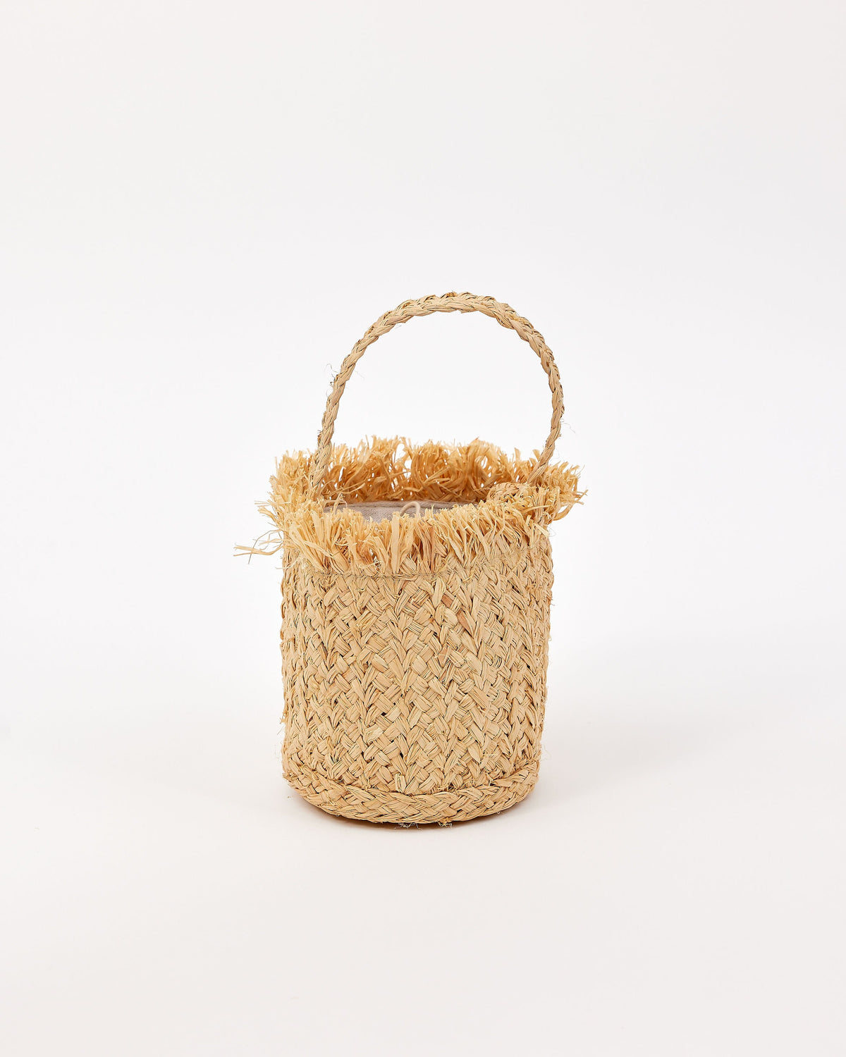 Woven mini bag with fringe detail and handle on a white background