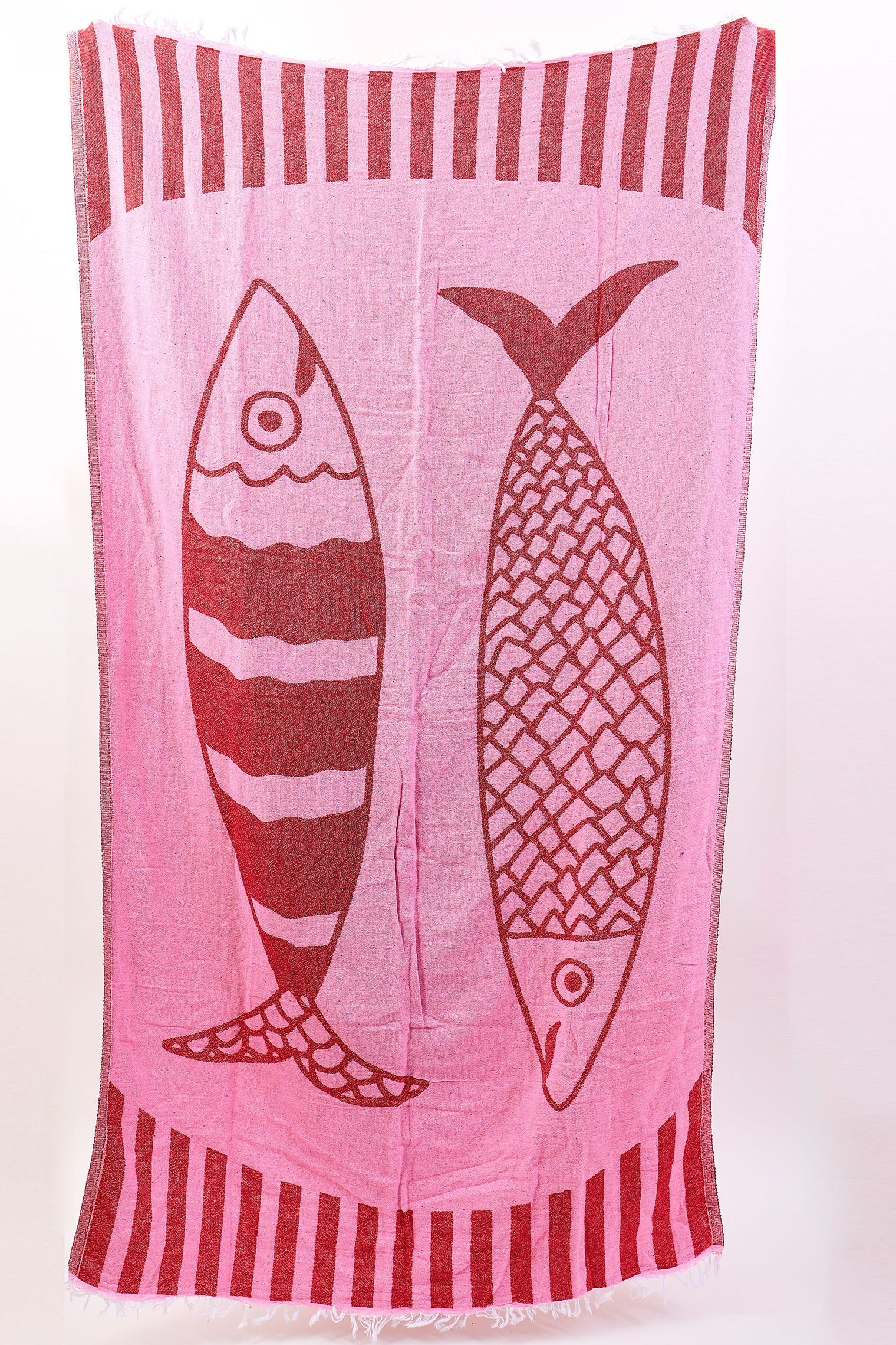 Towel with fish design and red and white stripes on a white background